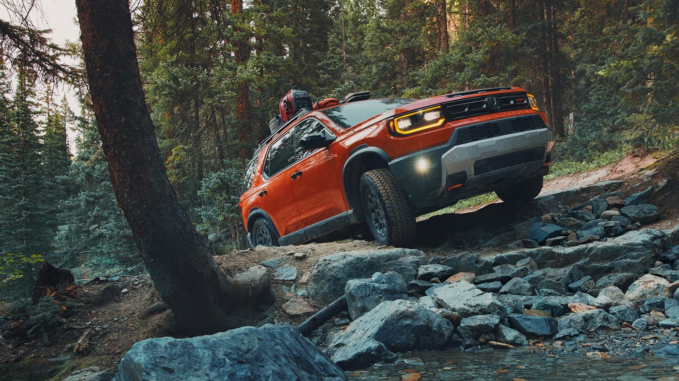 Honda Passport Driving Up On A Hill