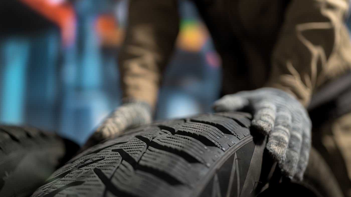 Mechanic Handling New Tire